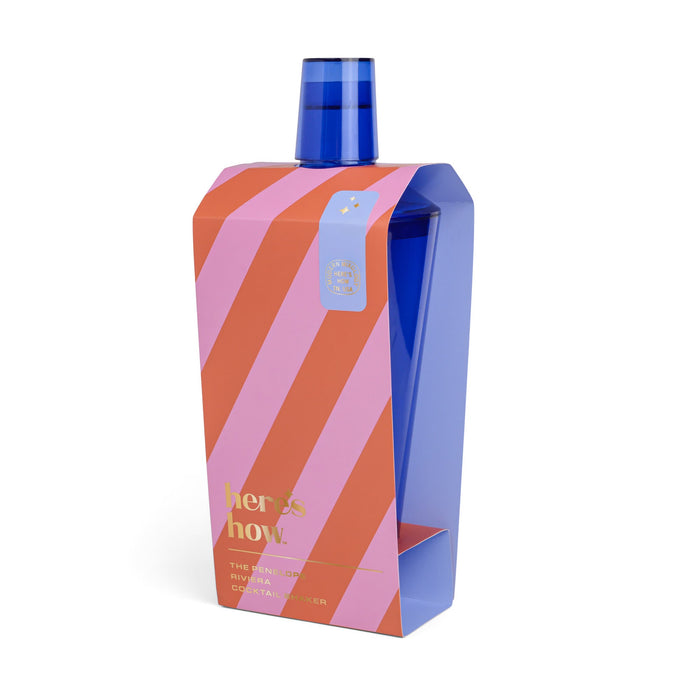 Blue cocktail shaker in a pink and orange striped box