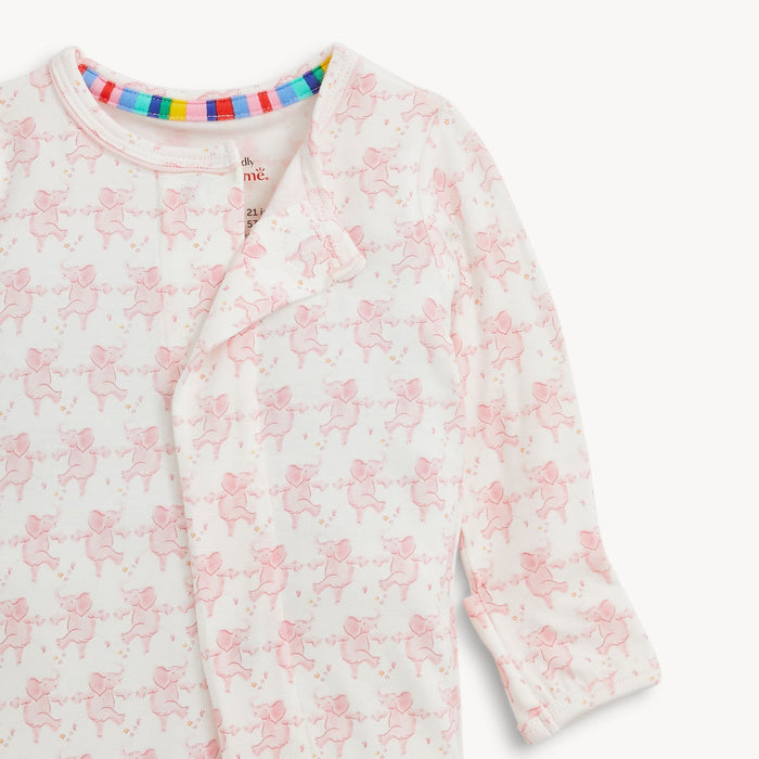 White baby onesie with pink elephant pattern and rainbow striped neck trim