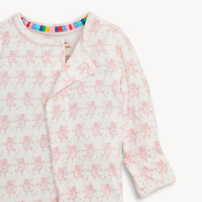 White baby onesie with pink elephant pattern and rainbow striped neck trim