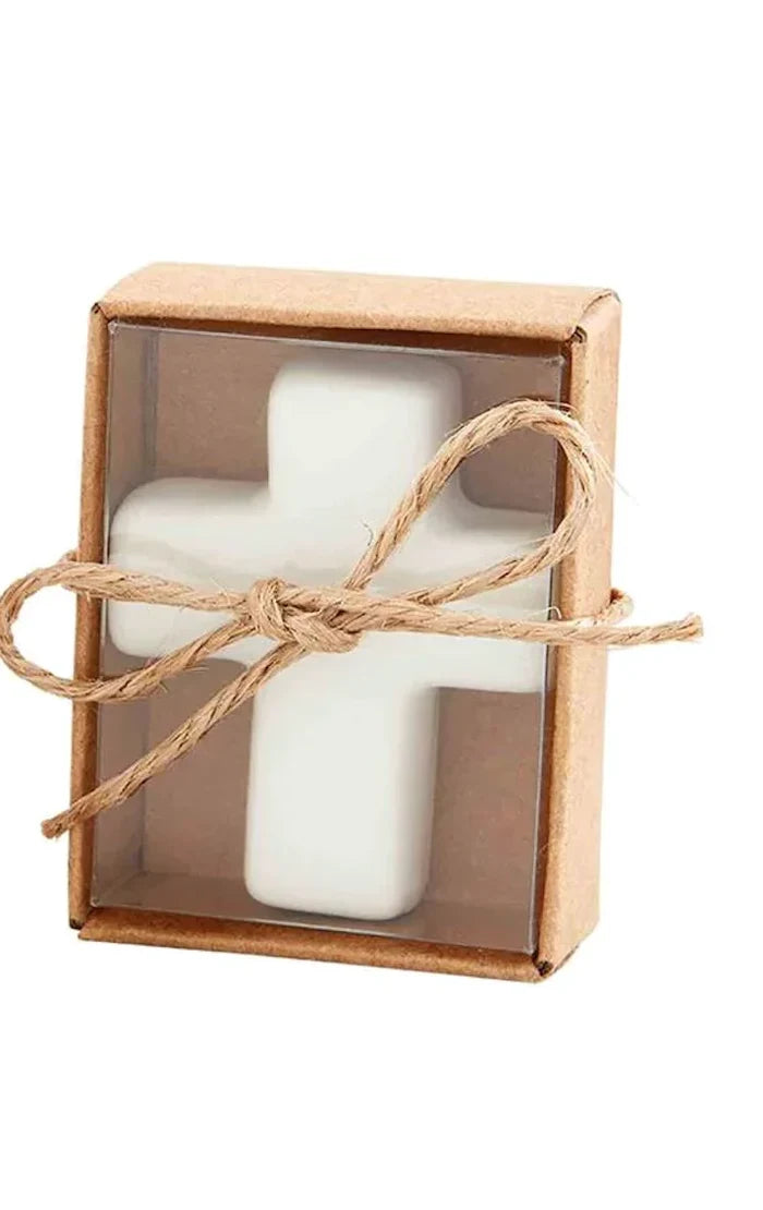 White ceramic cross pocket token in a kraft box tied with twine