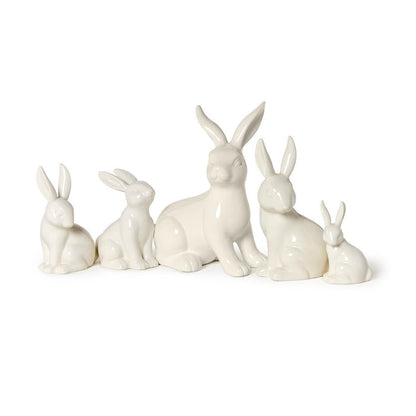 Five white porcelain bunny figures in assorted sizes