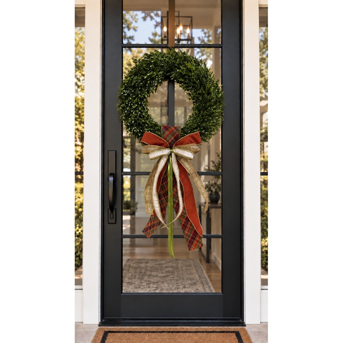 Pumpkin Please sash and bow on a boxwood wreath on a black glass front door