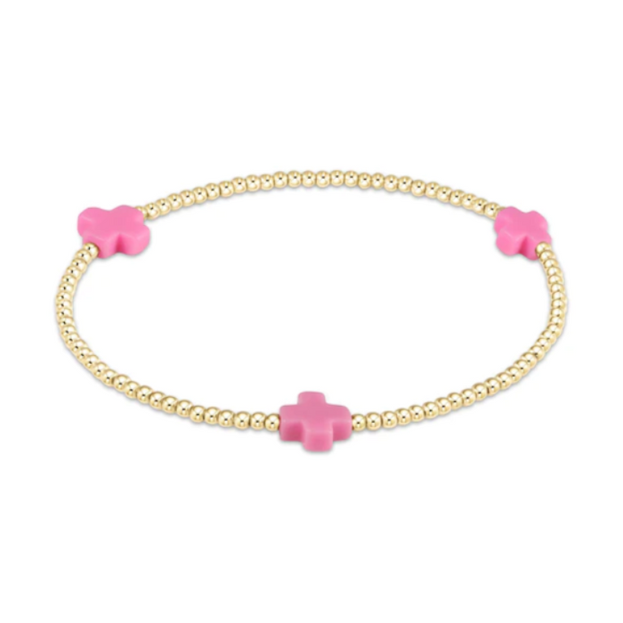 Gold beaded stretch bracelet with three pink cross charms