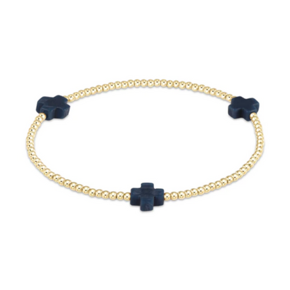 Gold beaded stretch bracelet with three navy cross charms