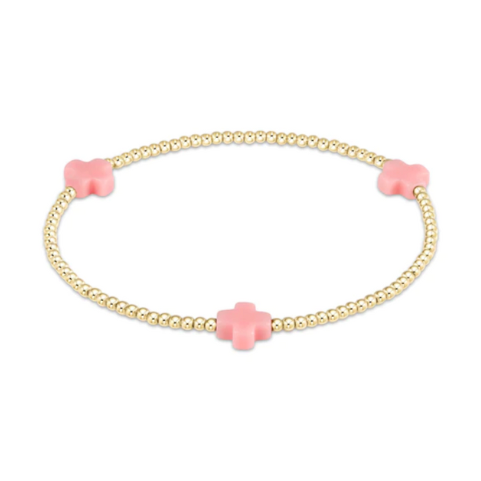 Gold beaded stretch bracelet with three light pink cross charms