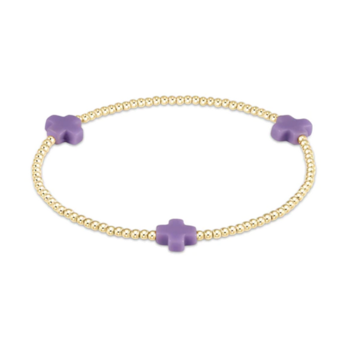 Gold beaded stretch bracelet with three purple cross charms