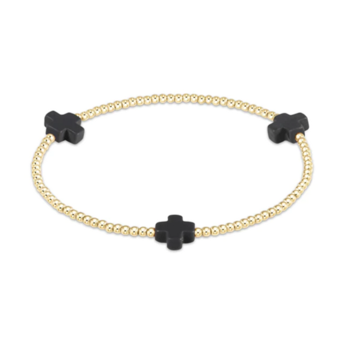 Gold beaded stretch bracelet with three black cross charms
