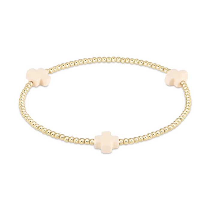 Gold beaded stretch bracelet with three cream cross charms