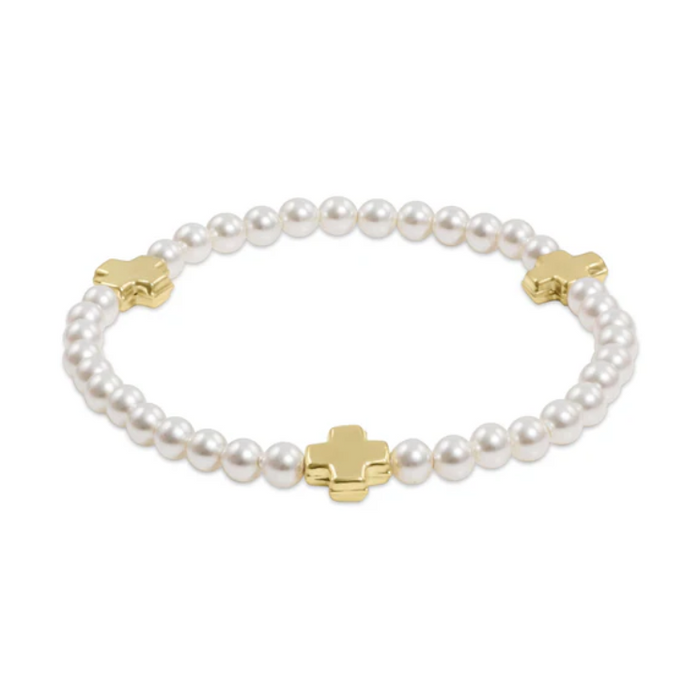 White pearl stretch bracelet with three gold cross beads