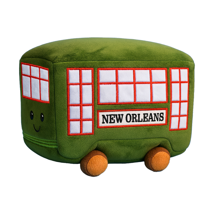 Green New Orleans streetcar plush with a smiling face and red windows