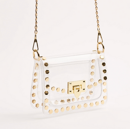 Side view of the clear gold-studded crossbody bag with gold chain