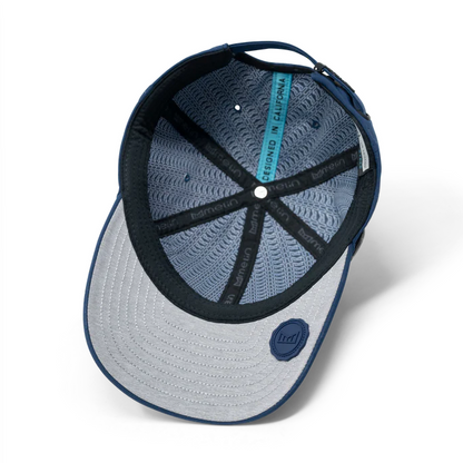 Underside of a navy melin cap with a gray brim