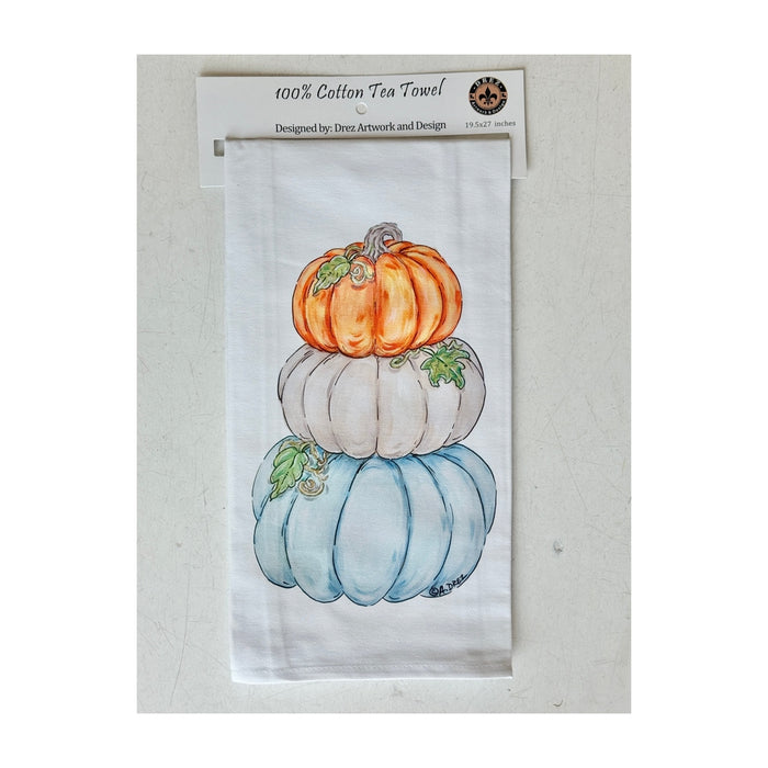 Cotton tea towel printed with stacked pumpkins in orange, white and blue