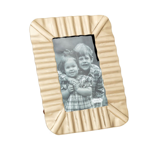 Brass ruffle frame with a black and white photo of two children