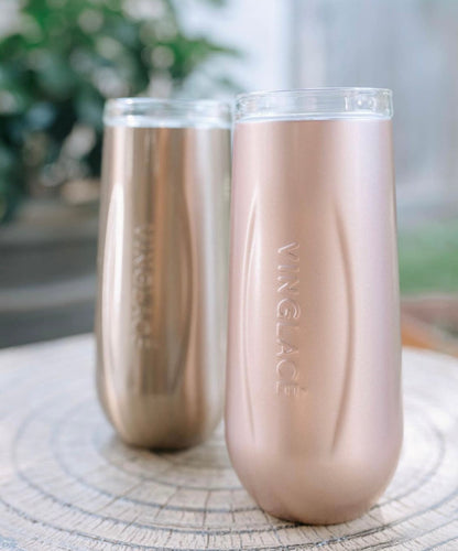 Two rose gold insulated champagne flutes